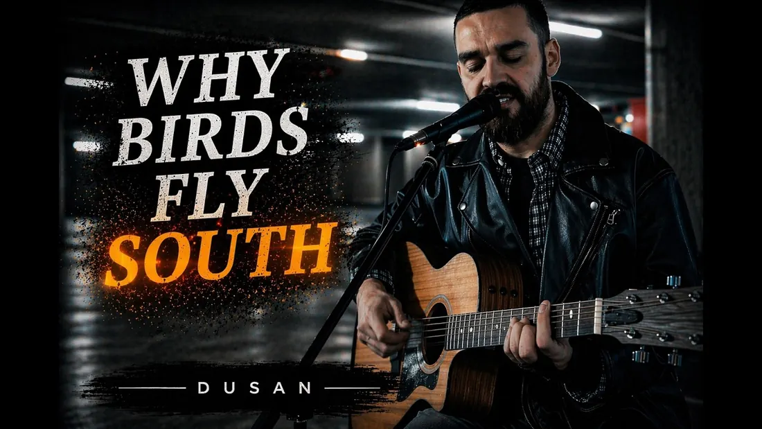Dusan in a leather jacket singing and playing acoustic guitar for the Why Birds Fly South music video